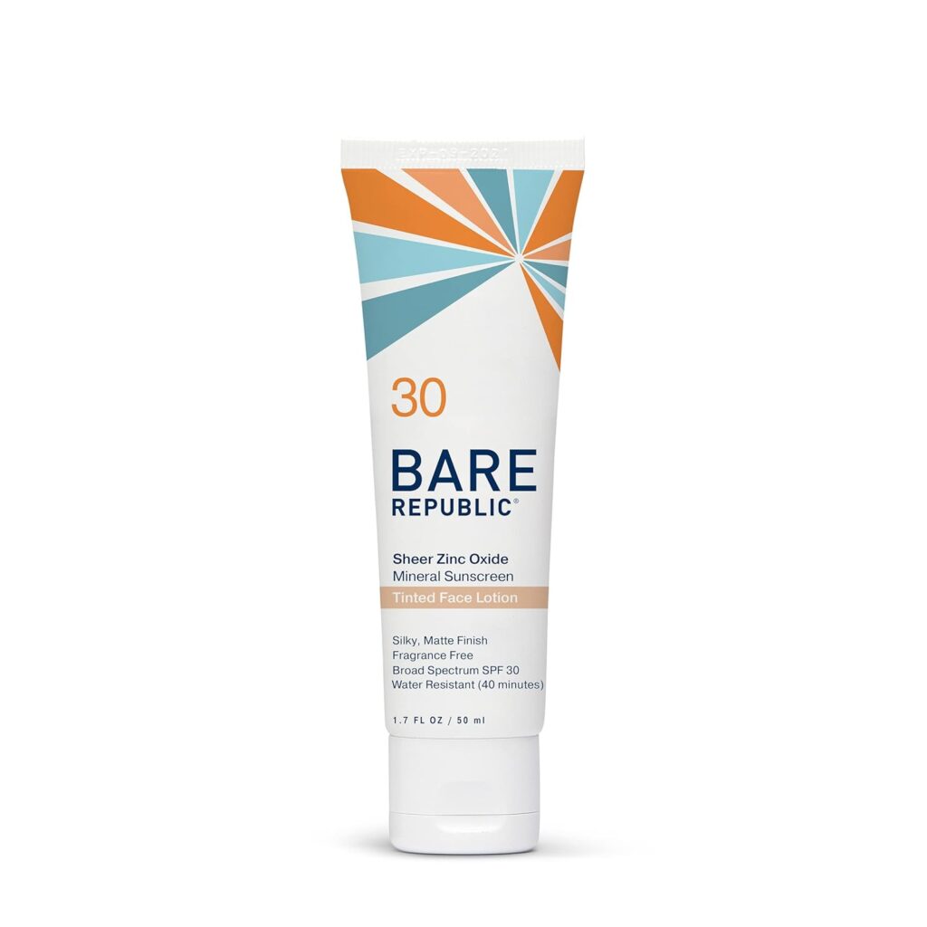Product photo of Bare Republic Sheer Zinc Oxide Mineral Sunscreen Tinted Face Lotion SPF 30. White tube features a retro sunburst design in orange and blue tones at the top.