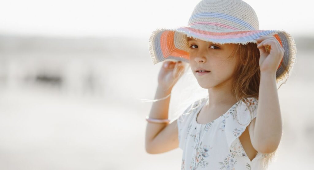 Child wearing sun hat as additional protection alongside Heliocare 360 Pediatrics Mineral Sunscreen SPF50 50ml