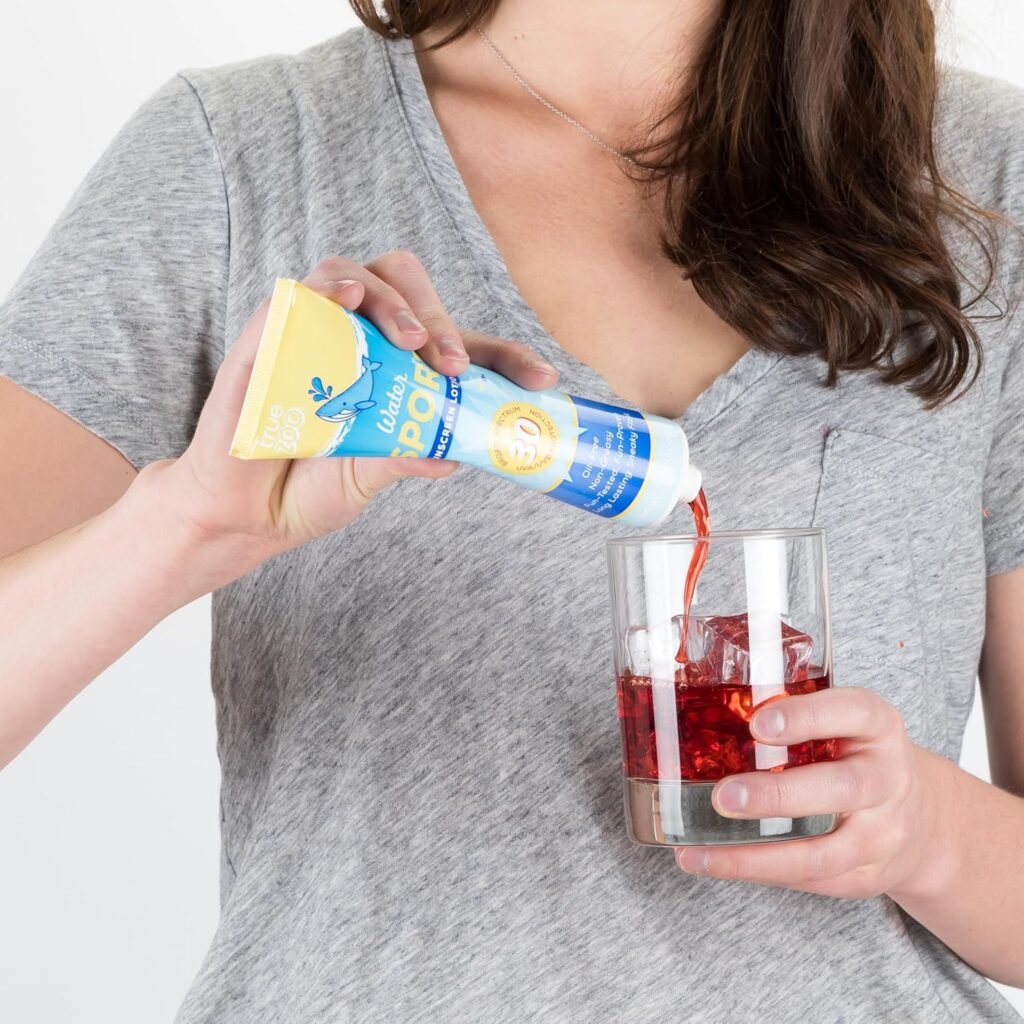 "Demonstration of TrueZoo sunscreen lotion flask being used to pour red liquid into a glass, showing its practical application