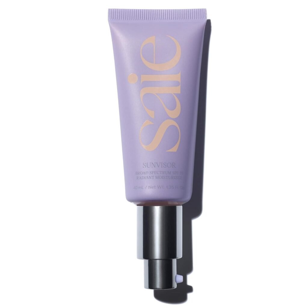 Saie Sunvisor broad spectrum SPF 35 radiant moisturizer best sunscreen for pale skin in a purple tube with gold text, featuring a silver pump dispenser, 40ml/1.36 fl. oz.
