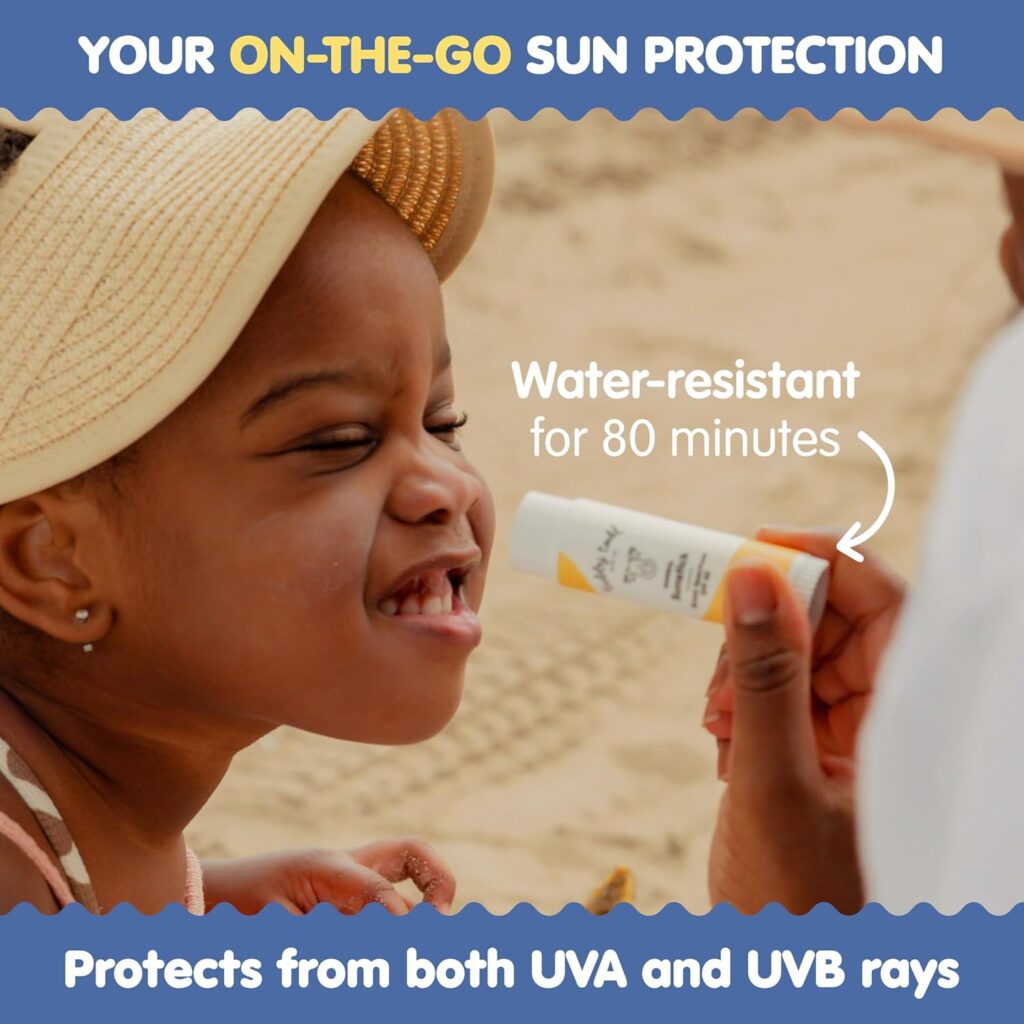 Child smiling at beach while using Tubby Todd water-resistant sunscreen for UVA and UVB protection