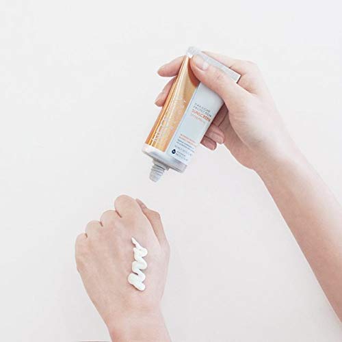 Hands dispensing and applying Neogen sunscreen, demonstrating the white lightweight texture of the Korean sun protection.