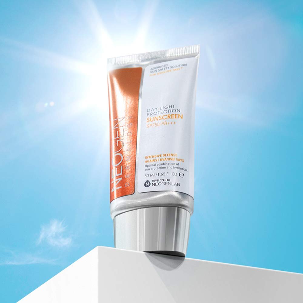 Neogen Dermalogy Day-Light Protection Sunscreen SPF50/PA+++ tube displayed against bright blue sky background for UV protection.