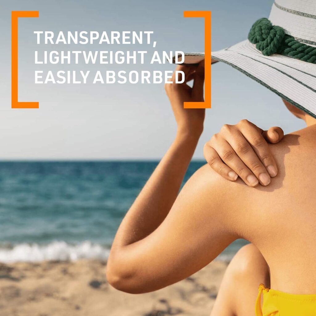 Person applying transparent, lightweight P20 sunscreen at the beach while wearing a sun hat