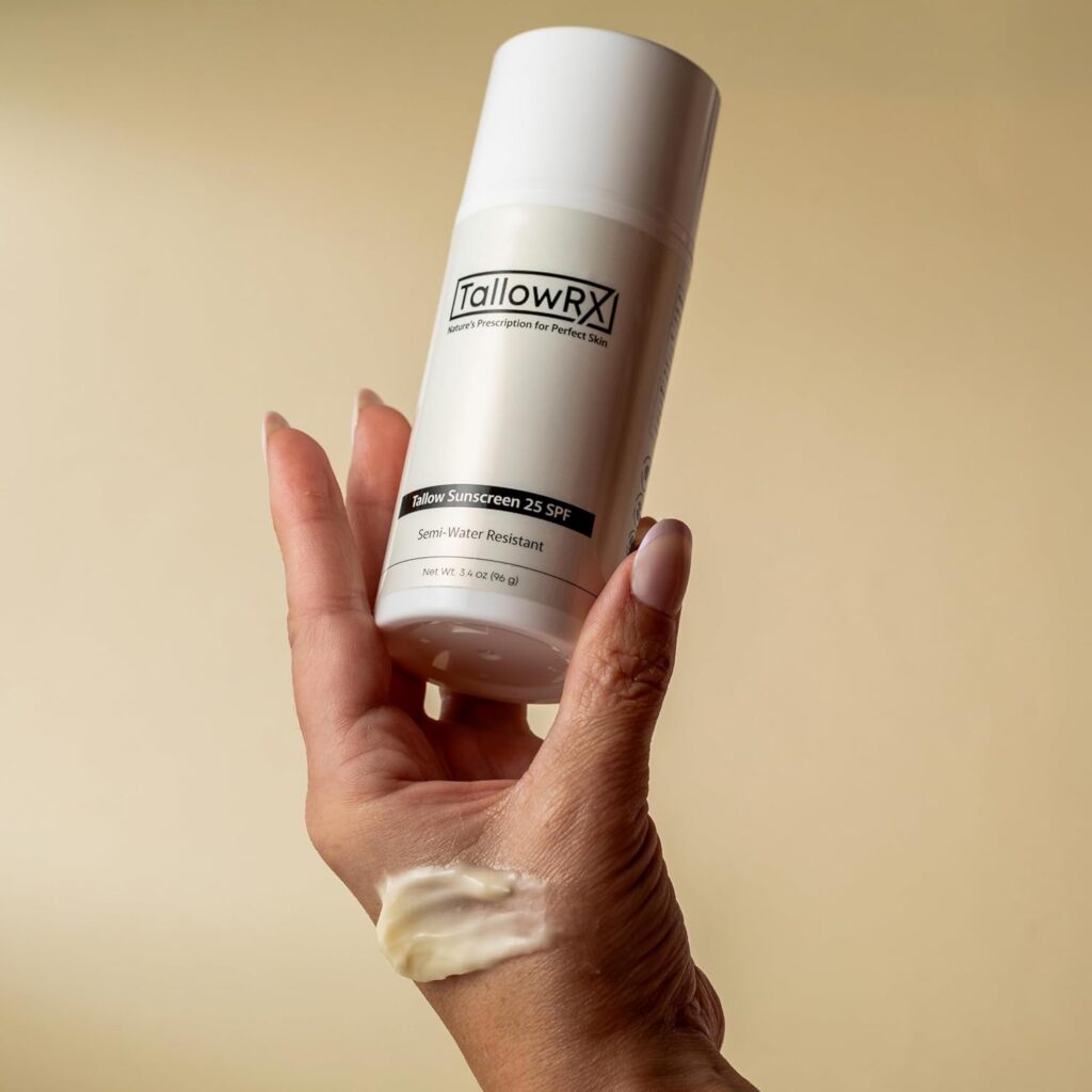 Hand holding TallowRX Tallow Sunscreen SPF 25 showing semi-water resistant natural sun protection with smooth texture
